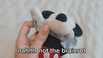 A Person Holding A Stuffed Mickey Mouse With The Words " Nahhh Not The Brainrot " Above It GIF