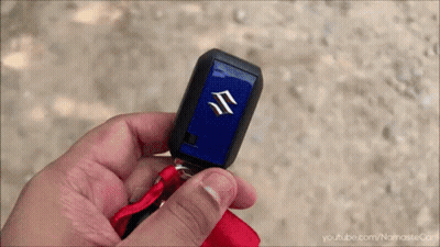 A Person Holding A Suzuki Car Key In Their Hand GIF