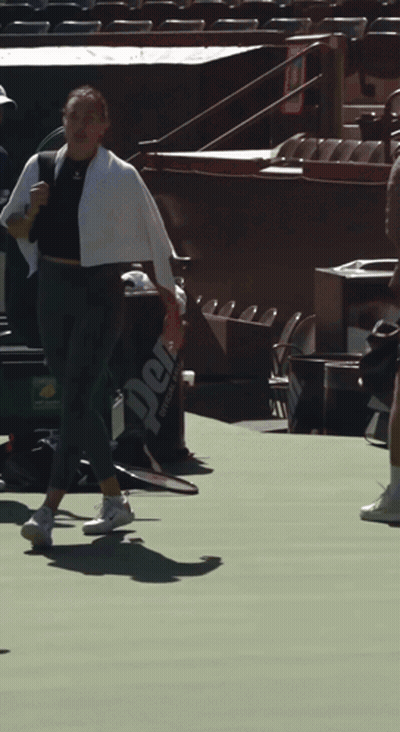 A Person Holding A Tennis Racquet On A Court With A Bag That Says Perf On It GIF