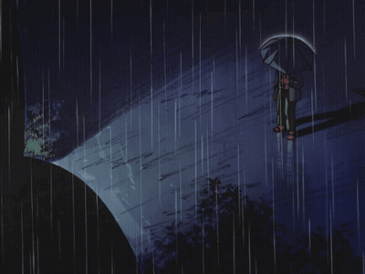 A Person Holding An Umbrella Stands In The Rain GIF