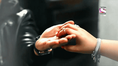 A Person Holding Another Person 'S Hand In Front Of A Sony Television Logo GIF