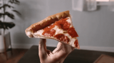 A Person Holds A Slice Of Pepperoni Pizza In Their Hand GIF