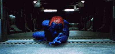 A Person In A Blue And Red Superhero Costume Is Laying On The Floor . GIF