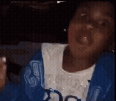 A Person In A Blue Jacket Is Making A Funny Face While Sitting In A Car . GIF