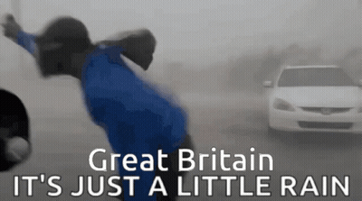 A Person In A Blue Shirt Is Standing In The Rain With The Words Great Britain It 'S Just A Little Rain On The Bottom GIF