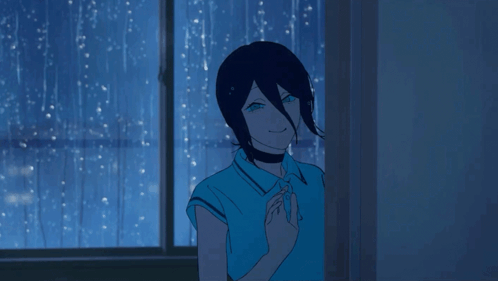 A Person In A Blue Shirt Stands In Front Of A Window With Rain Drops On It GIF