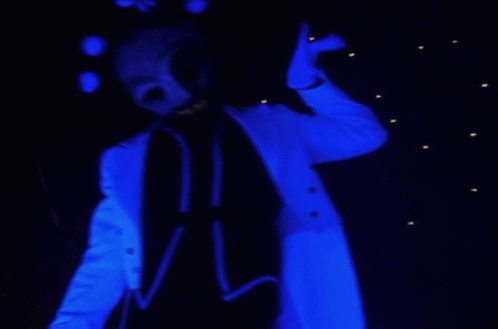 A Person In A Blue Suit With A Skull Mask On Their Face GIF