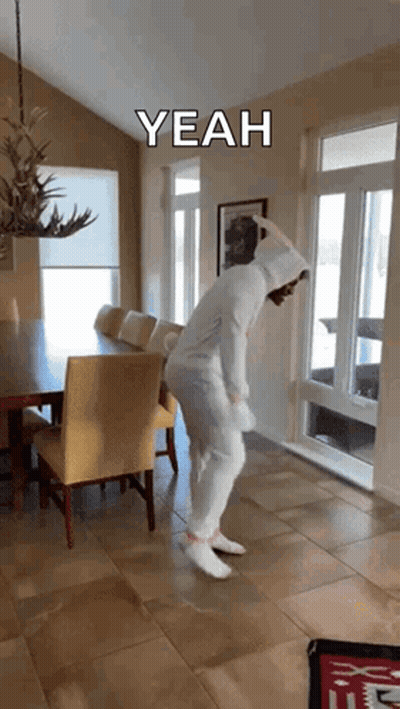 A Person In A Bunny Costume Is Dancing In A Dining Room With A Caption That Says " Yeah " GIF