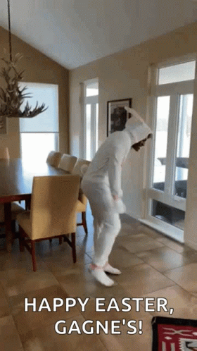 A Person In A Bunny Costume Is Dancing In A Living Room With The Words Happy Easter , Gagne 'S GIF