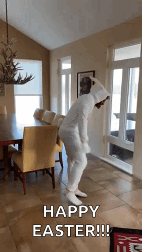A Person In A Bunny Costume Is Dancing In A Room With The Words Happy Easter Written On The Bottom GIF