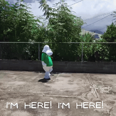 A Person In A Bunny Costume Is Standing In A Parking Lot And Says I 'M Here GIF