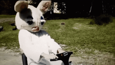 A Person In A Bunny Mask Is Riding A Scooter GIF