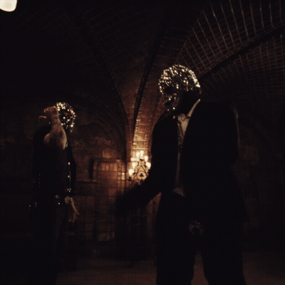 A Person In A Dark Room With A Mask On GIF