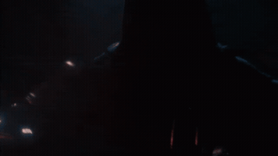 A Person In A Dark Room With A Red Light Coming Out Of Their Mouth GIF