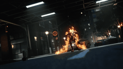 A Person In A Fire Suit Is Standing On A Street GIF