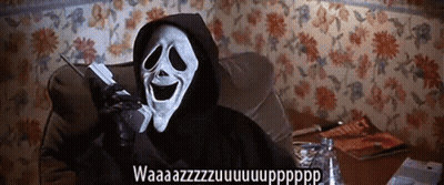 A Person In A Grim Reaper Costume Is Talking On A Phone GIF