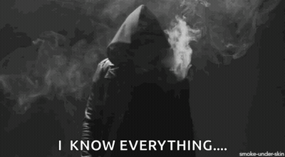 A Person In A Hooded Jacket Is Smoking A Cigarette And Says I Know Everything GIF
