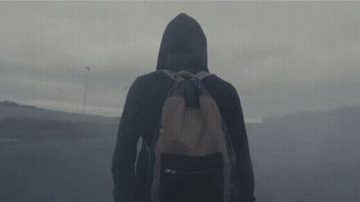 A Person In A Hooded Jacket With A Backpack GIF