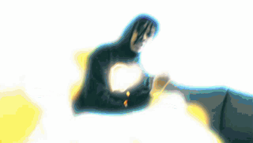 A Person In A Hoodie With A Heart On It GIF