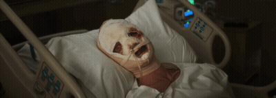 A Person In A Hospital Bed With A Bandaged Face GIF