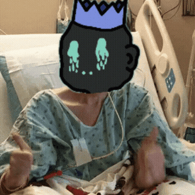 A Person In A Hospital Bed With A Cartoon Character On Their Head GIF