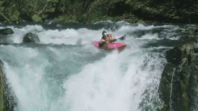 A Person In A Kayak Going Down A Waterfall GIF