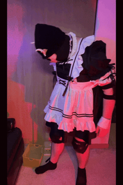 A Person In A Maid Costume Is Standing Next To A Yellow Box GIF