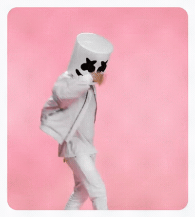 A Person In A Marshmallow Costume Is Standing On A Pink Background . GIF