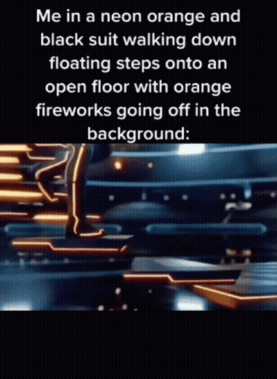 A Person In A Neon Orange And Black Suit Is Walking Down Floating Steps Onto An Open Floor With Orange Fireworks Going O GIF