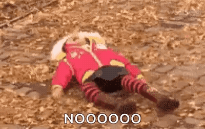 A Person In A Red Jacket And Striped Pants Is Laying On Their Back On The Ground . GIF