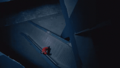 A Person In A Red Jacket Is Walking Down A Staircase GIF