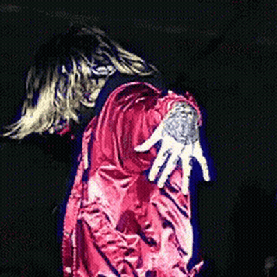 A Person In A Red Jacket With A Tattoo On Their Shoulder GIF
