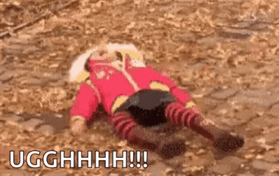 A Person In A Red Outfit Is Laying On The Ground With The Words Ugghhhh Written Above Them GIF