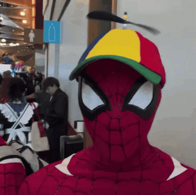 A Person In A Spiderman Costume With A Colorful Hat GIF