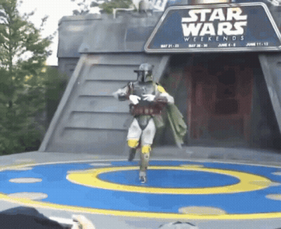 A Person In A Star Wars Costume Is Dancing In Front Of A Star Wars Weekends Sign GIF