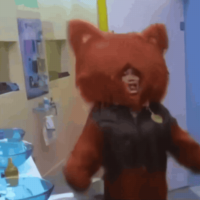 A Person In A Teddy Bear Costume Is Standing In Front Of A Bathroom Sink GIF