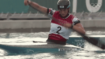 A Person In A Tokyo 2020 Shirt Is Paddling A Kayak GIF