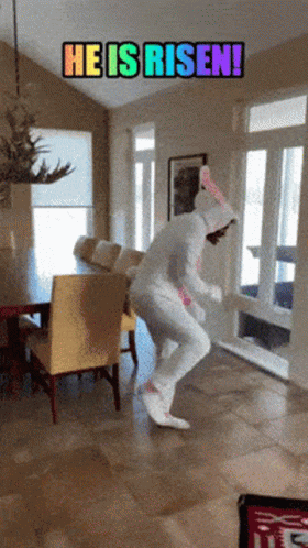 A Person In A Unicorn Costume Is Jumping In A Room With The Words He Is Risen On The Bottom GIF