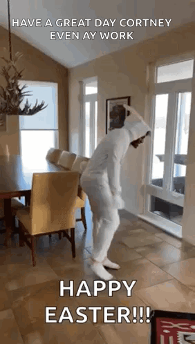 A Person In A White Bunny Suit Is Dancing In A Living Room . GIF