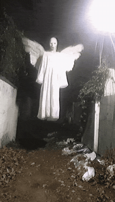 A Person In A White Dress With Wings Is Flying In The Air GIF