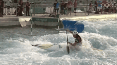 A Person In A White Helmet Is Paddling A Kayak In A Pool With A Sign That Says Tokyo 2020 GIF