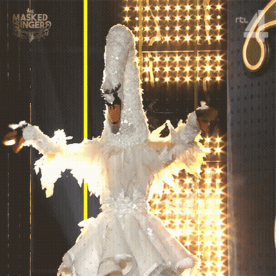 A Person In A White Swan Costume Is On The Masked Singer Stage GIF
