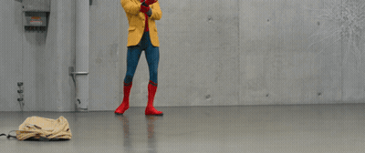 A Person In A Yellow Jacket Stands In Front Of A Wall With Snowflakes Drawn On It GIF