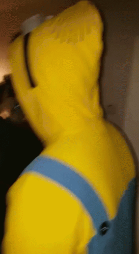 A Person In A Yellow Minion Costume With A Hood On GIF