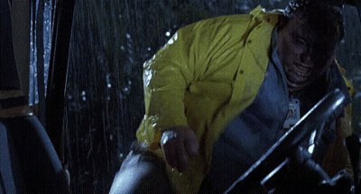 A Person In A Yellow Raincoat Is Driving A Vehicle GIF