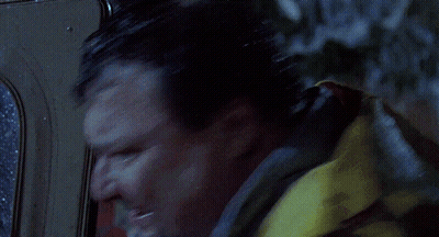 A Person In A Yellow Raincoat Is Standing In The Rain GIF