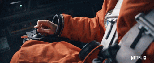 A Person In An Orange Suit Is Using A Netflix Advertisement GIF