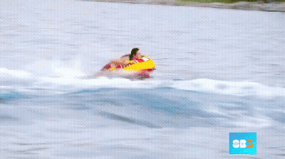 A Person Is Being Towed By A Boat With Cbs On The Bottom Right GIF
