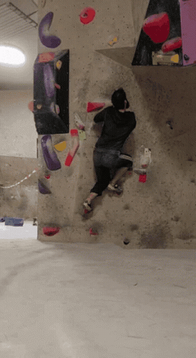 A Person Is Climbing Up A Climbing Wall With A Lot Of Holds GIF