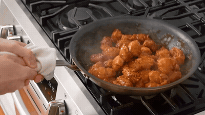 A Person Is Cooking Food In A Pan On A Stove That Has A Button That Says ' Off ' On It GIF